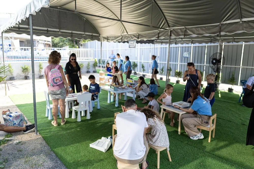 Families exploring Montessori activities during an ISPG event