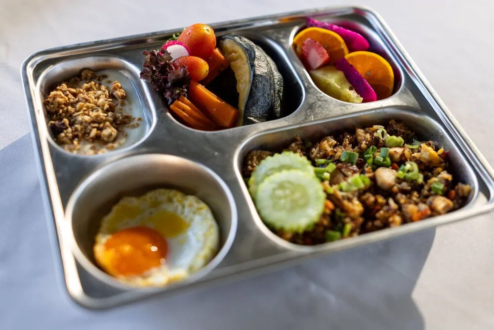 A nutritious school meal with egg, vegetables, fruit and grains